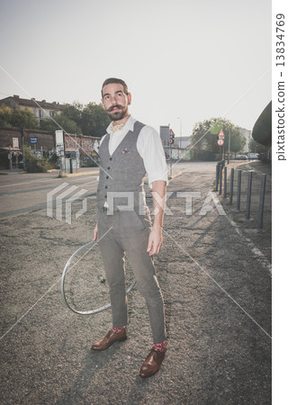 handsome big moustache hipster man holding old bicycle wheel 13834769