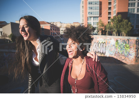 two multiethnic beautiful young woman black and white having fun 13834950