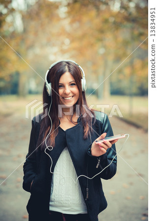 young beautiful brunette straight hair woman in the park 13834951