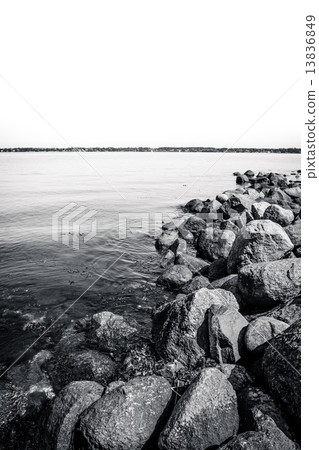 Black and white ocean landscape with rocks 13836849