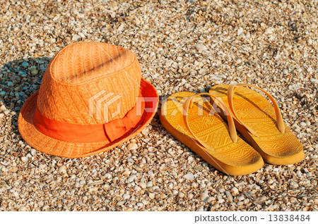 Bright summer hat and sandals on the beach at shells Bright summer hat and sandals on the beach at shells 13838484