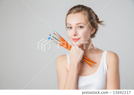 Close-up of smiling artist-girl with paintbrushes. Close-up of smiling artist-girl with paintbrushes. 13842217