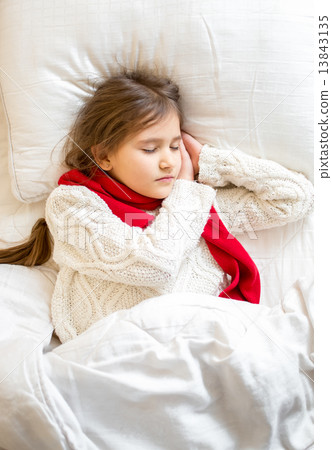 portrait of little girl in sweater sleeping at bed portrait of little girl in sweater sleeping at bed 13843135