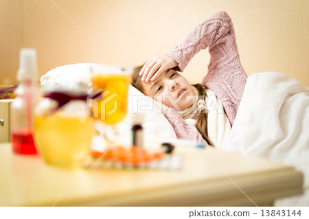 little sick girl with high temperature lying in bedroom 13843144