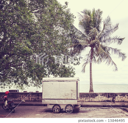 Retro filtered picture of food cart on seaside street. 13846495