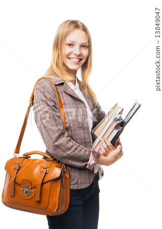 Smiling young girl standing with bag and books 13849047