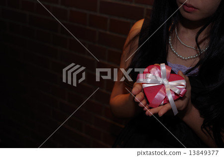 Give present dress in an atmospherey place 13849377