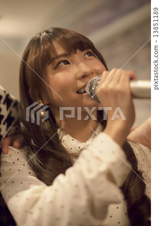 A cute girl singing karaoke 13851189