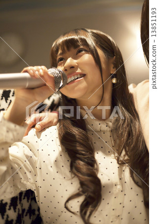 A cute girl singing karaoke 13851193