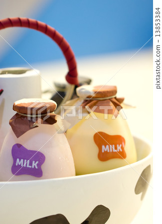 Close up shot bottles of milk in basket. 13853384