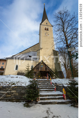 stone church with high belfry in Austrian Alps 13854039