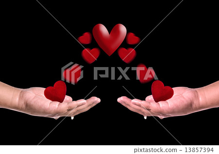 Red hearts fly into hands on black background . Love concept Red hearts fly into hands on black background . Love concept 13857394