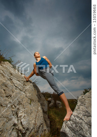 Woman doing yoga against the setting sun Woman doing yoga against the setting sun 13859668