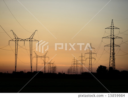 Large transmission towers at sunset 13859984