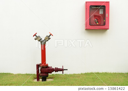 The red fire hydrant and fire hose 13861422