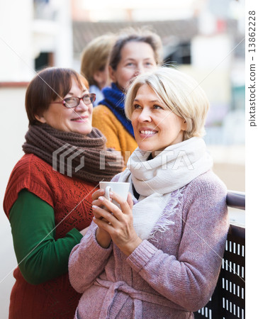 Senior women drinking tea at balcony 13862228