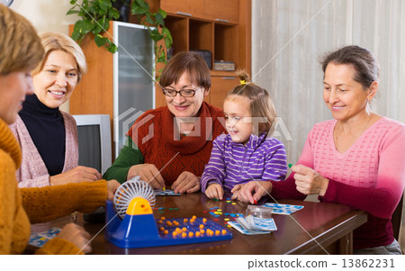 Senior women with child at desk with bingo Senior women with child at desk with bingo 13862231