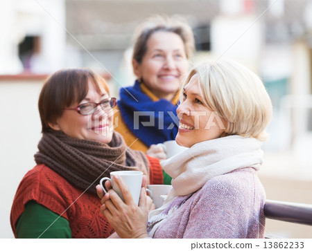 Senior women drinking tea at balcony 13862233