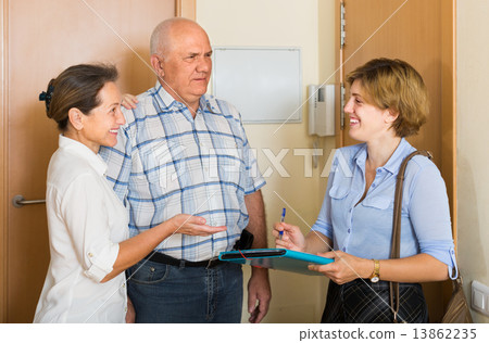 Senior couple with social worker at home Senior couple with social worker at home 13862235