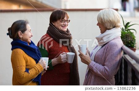 Senior women drinking tea at balcony 13862236