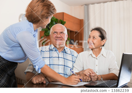 Mature couple answer questions of outreach worker Mature couple answer questions of outreach worker 13862239