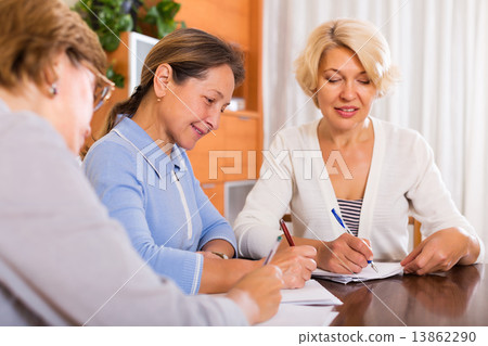 Cheerful female pensioners making list 13862290