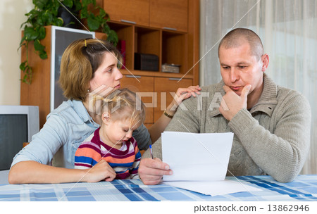 Worried family with financial documents 13862946