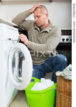 Man doing laundry Man doing laundry 13862948