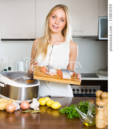 Woman cooking with multicooker 13863059