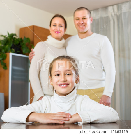 Happy couple with daughter at home 13863119