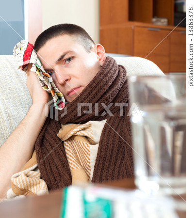 sick man uses handkerchief on head 13863378