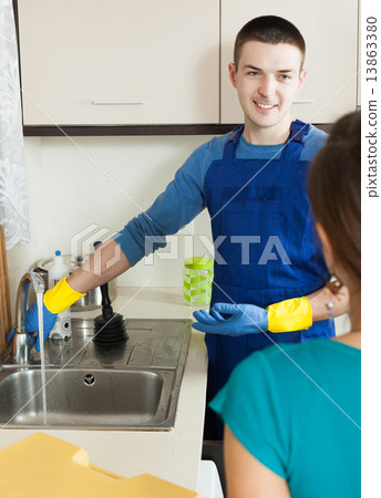 Plumber in repairing a running water 13863380