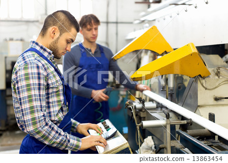 Workers cutting window profiles 13863454