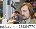 Portrait of a pensive and handsome young man in coffee shop 13864770