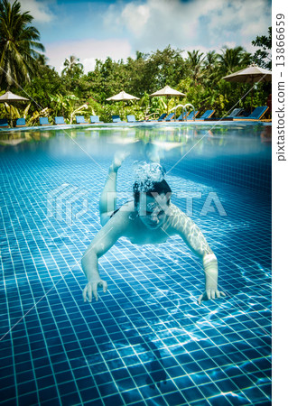 Man floats underwater in pool Man floats underwater in pool 13866659