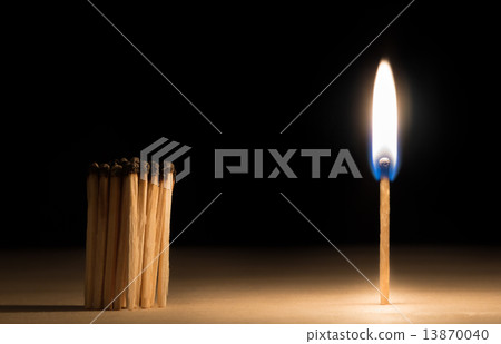 Crowd of burnt  matches standing before match on fire concept of 13870040