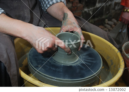 potter's wheel and hands of craftsman 13872002