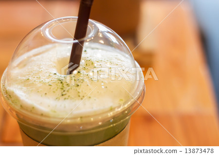 Iced green tea latte with milk foam 13873478