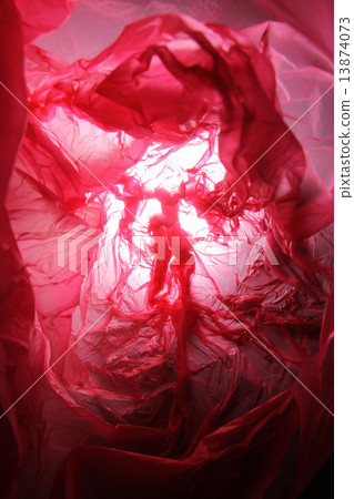 Abstract background of the insides of a red plastic bag with different color shades Abstract background of the insides of a red plastic bag with different color shades 13874073