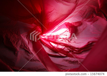 Abstract background of the insides of a red plastic bag with different color shades 13874074