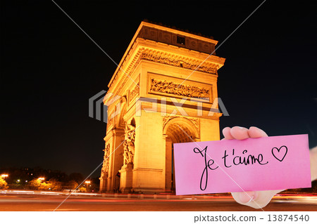 Composite image of hand holding card showing je taime 13874540