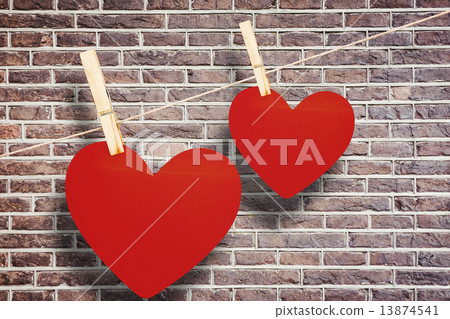 Composite image of hearts hanging on a line 13874541