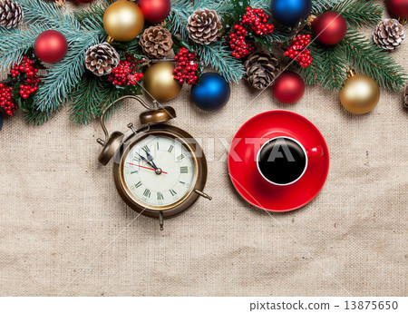 Hot cappuccino with christmas tree shape and alarm clock on a ta Hot cappuccino with christmas tree shape and alarm clock on a ta 13875650