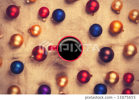 Hot coffee and christmas balls on jute background. Hot coffee and christmas balls on jute background. 13875655