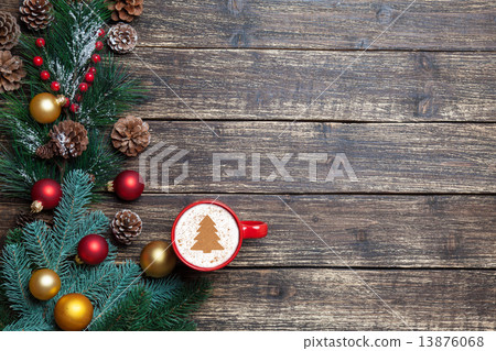 Cappuccino with christmas tree shape and pine branch on wooden t Cappuccino with christmas tree shape and pine branch on wooden t 13876068