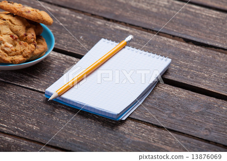 Cookie and pencil with notebook. 13876069