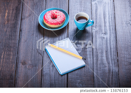 Cup of coffee with notebook and donut. Cup of coffee with notebook and donut. 13876153