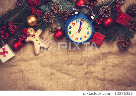 Christmas gifts and alarm clock on jute background. 13876326