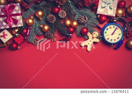 Christmas gifts and alarm clock with gingerbread on a red backgr Christmas gifts and alarm clock with gingerbread on a red backgr 13876411