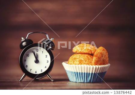Alarm clock and cupcake. Alarm clock and cupcake. 13876442